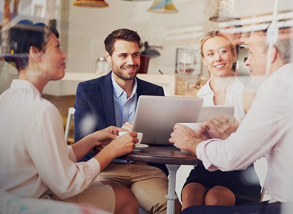 Travel costing your business - businesspeople sitting in a meeting room