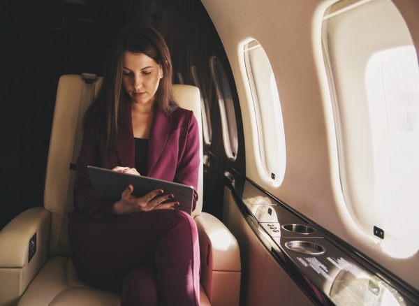 Woman in business class working while in-flight